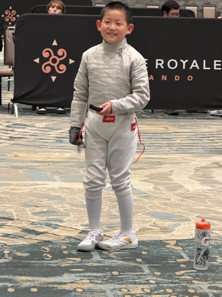 Young CSFA fencer in full competition gear ready to fence
